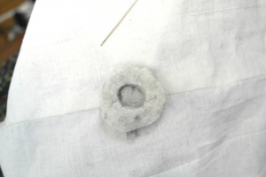 5. Sandwich the conductive fabric between the two circles of thick, resistive fabric and sew all three layers together