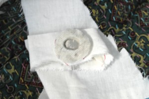 2. Make a hole in the thin fabric and sew the circle from Step One into the center.