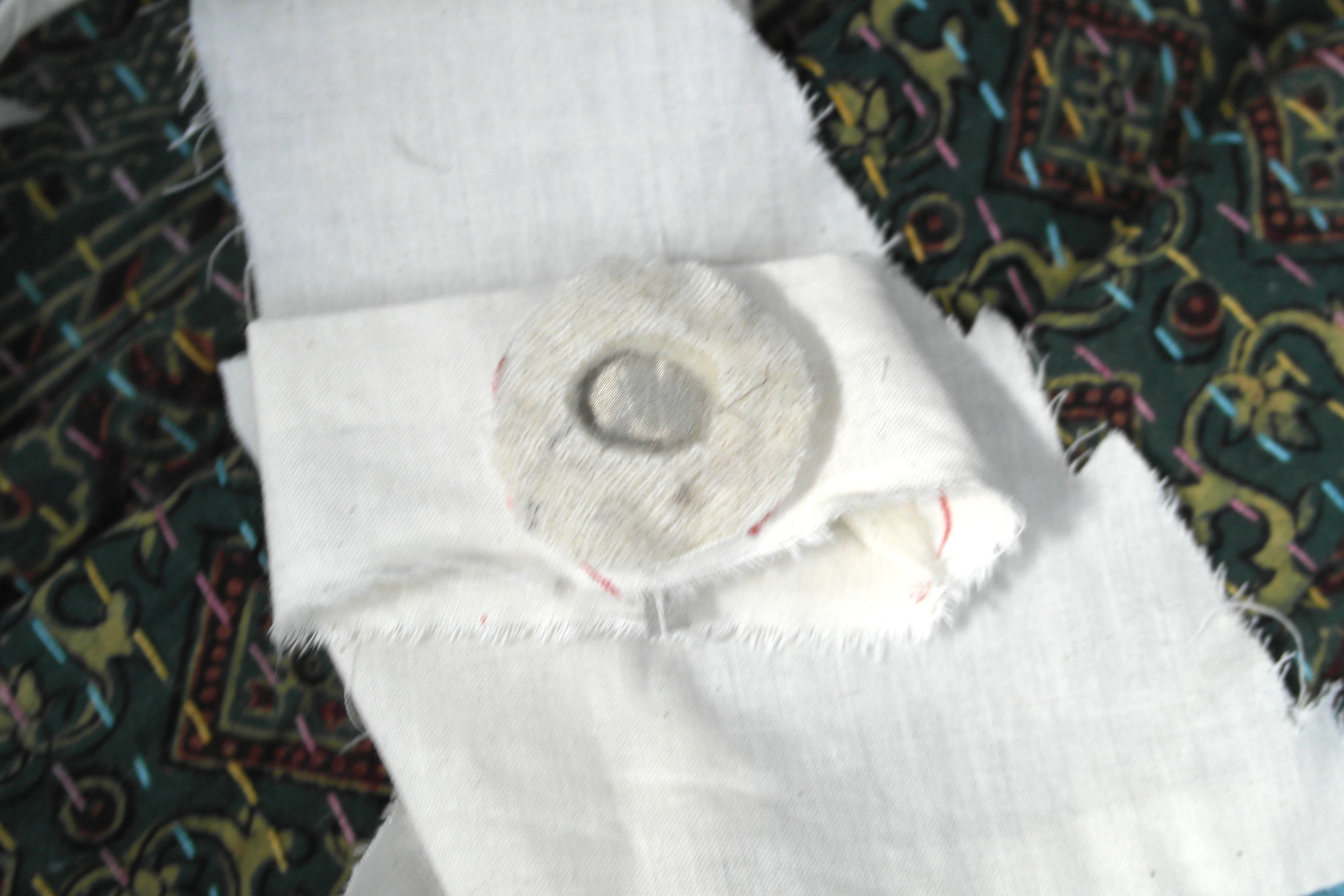 2. Make a hole in the thin fabric and sew the circle from Step One into the center.