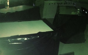 all nine tables within the classroom were covered with trash bags to create a dark, intimate, and uncomfortable environment