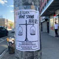 This is a picture of a sign post that says 'Rent Strike' in English, Spanish, and Chinese -- taken in Sunset Park, NYC.