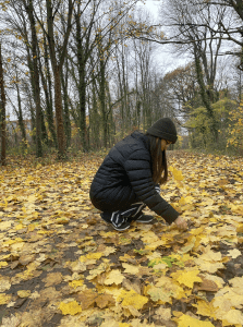 This is a photo of me in the Meudon forest in Paris, France. I really enjoyed exploring the city and I love leaves! This photo represents me because I've been making nature art specifically about leaves since I was a kid.