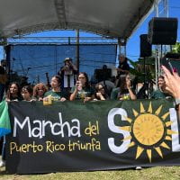 Organizers from Casa Pueblo, the grassroots organization that organizes Marcha del Sol, are holding a banner with the logo of the March and the slogan: Puerto Rico triumphs.