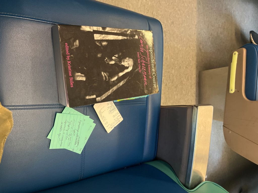 This image is of my book Correspondence Course: an epistolary history of Carolee Schneemann and her circle. The book is sitting on the seat of a train, surrounded by my train ticket and my notes on the letters in the text.