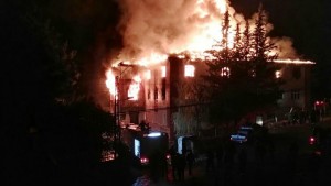 TURKEY OUT Flames are seen as firefighters try to control a fire at a school in Adana, southern Turkey, on November 29, 2016. Twelve people, most of them children, were killed on Tuesday when the fire broke out at a dormitory of the school, local officials said. "12 bodies were recovered, 22 wounded people were taken to hospitals," Adana governor Mahmut Demirtas was quoted as saying by the official news agency Anadolu. Adana Mayor Huseyin Sozlu told the private NTV broadcaster 11 of the dead were secondary school students and the other victim was a female caretaker. / AFP PHOTO / DOGAN NEWS AGENCY / - / Turkey OUT