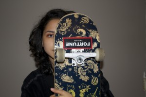 This photograph is of a female hidden behind her skateboard. Only half of her face is revealed for the viewer because she fears that society may not accept her to take on masculine features and a “man’s sport.” However, she still rides the wheels of fortune without fear of acceptance. 